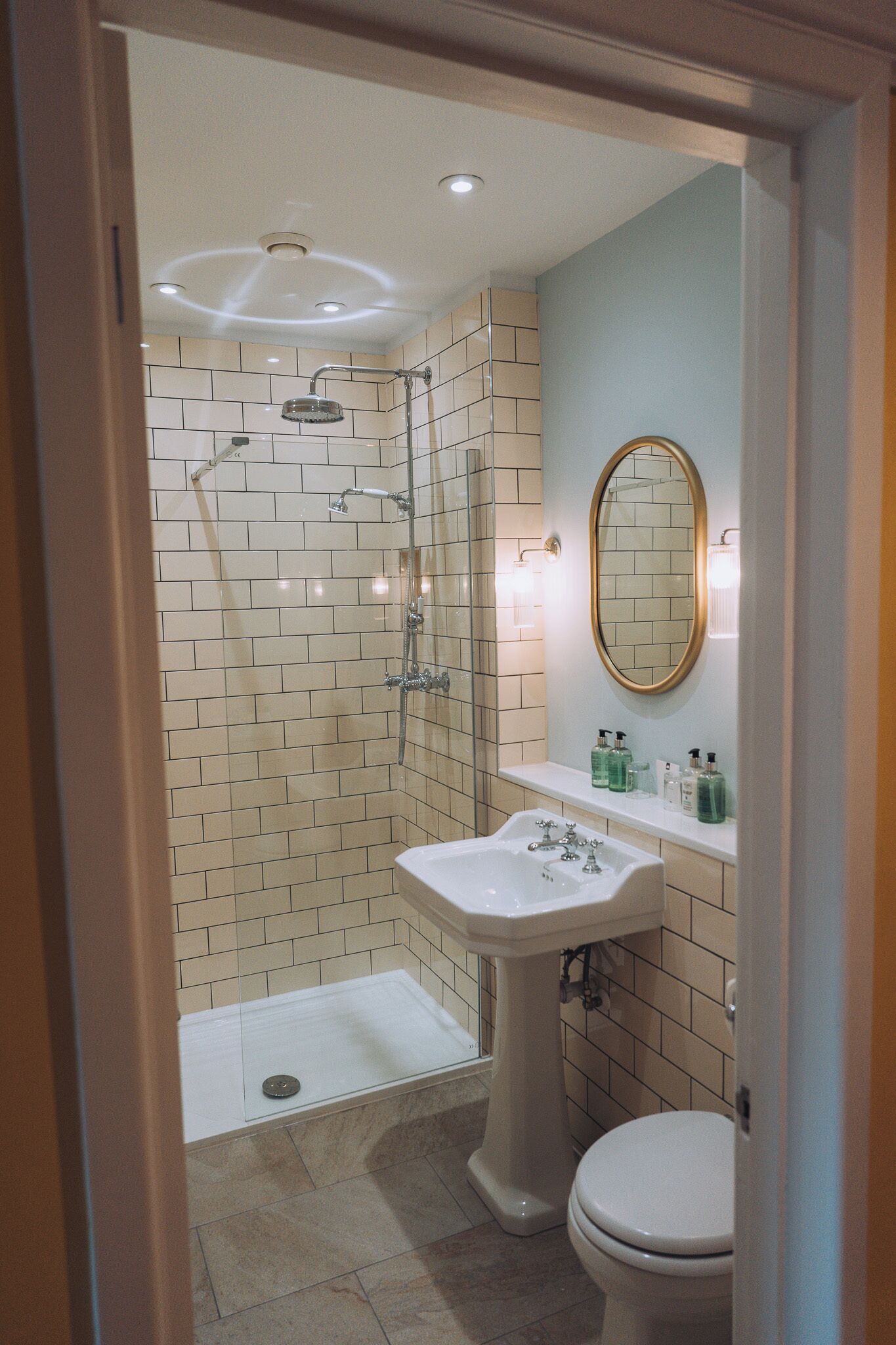 A bathroom with a shower, sink, and toilet.