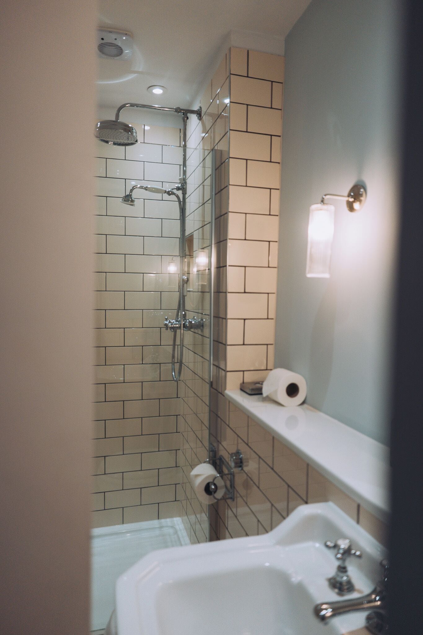 A bathroom with a shower, toilet, and sink.