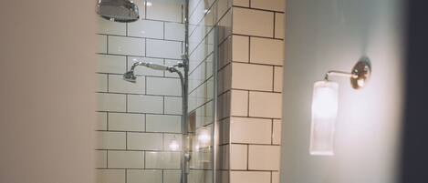 A bathroom with a shower, toilet, and sink.