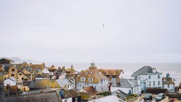 A coastal town with historic buildings, a prominent church, and a view of the sea.