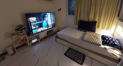 A cozy place with a double bed with 65 inches TV. Free Netflix and Youtube