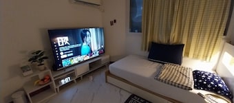 A cozy place with a double bed with 65 inches TV. Free Netflix and Youtube