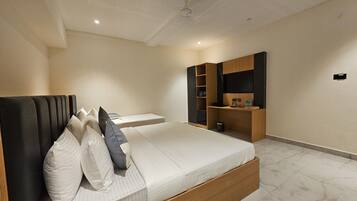 A modern bedroom with a bed, bedside tables, a wardrobe, and a mirror.