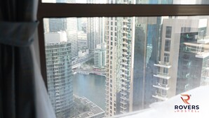 A high-rise building with a view of a river and other buildings. - Rovers Beach Hostel JBR (Dubai)