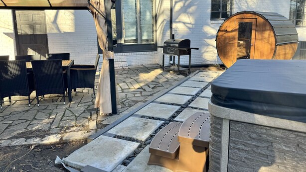 A patio with outdoor furniture, a barbecue grill, and a hot tub. - Raleigh Retreat with Sauna+Hot Tub (Garner)