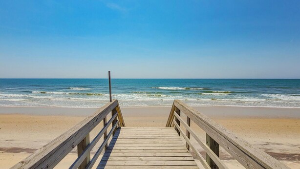 A wooden boardwalk leading to a beach with clear skies. - Good Day Sunshine: Pool +Dock +Ocean Views! (North Topsail Beach)