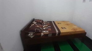 Una habitación pequeña y estrecha con una cama individual.