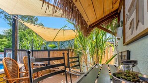 A wooden deck with outdoor seating, a pool, and tropical plants. - Where Comfort Meets Class: Your Private 1B Luxury Retreat Awaits! (Largo)