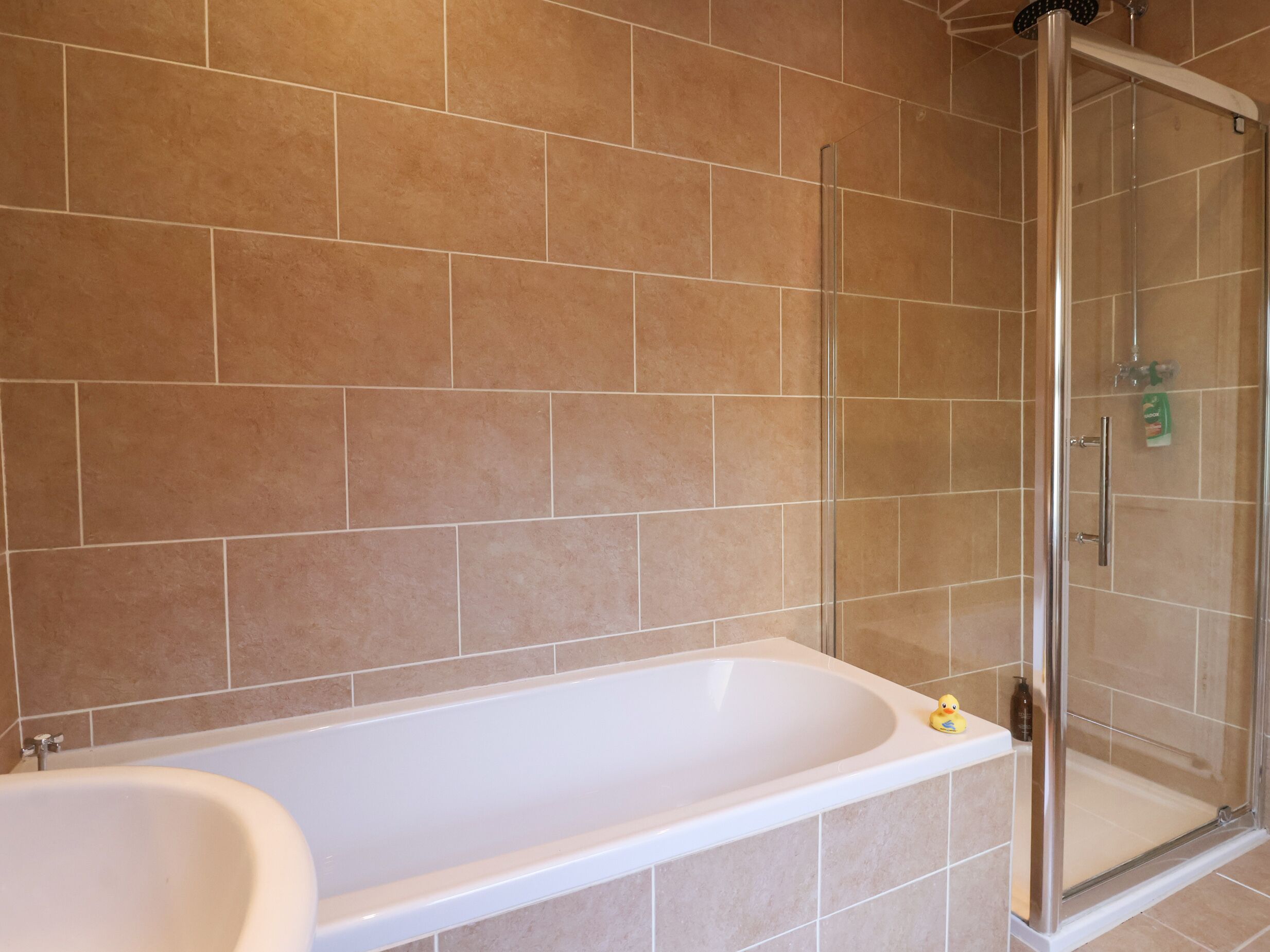 A bathroom with a bathtub, a shower, and a toilet.