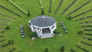 A large, white, octagonal gazebo with a central dome, surrounded by neatly trimmed hedges and a circular driveway. - Lavender Farm Private Luxury Suite (South Kingstown)