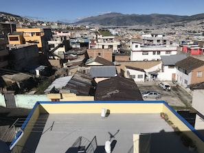 A residential area with various buildings, including a yellow building with a blue roof and a white building with a red door.