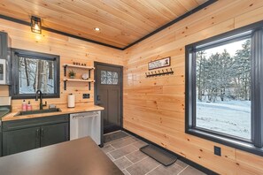 Enjoy a tranquil atmosphere in this kitchen with a sink, dishwasher, and ample countertop space.