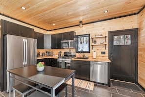 Enjoy cooking in this well-equipped kitchen with a refrigerator, stove, and dishwasher.