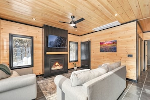 Relax in this stylish living room with a fireplace, flat-screen TV, and comfortable sofas.