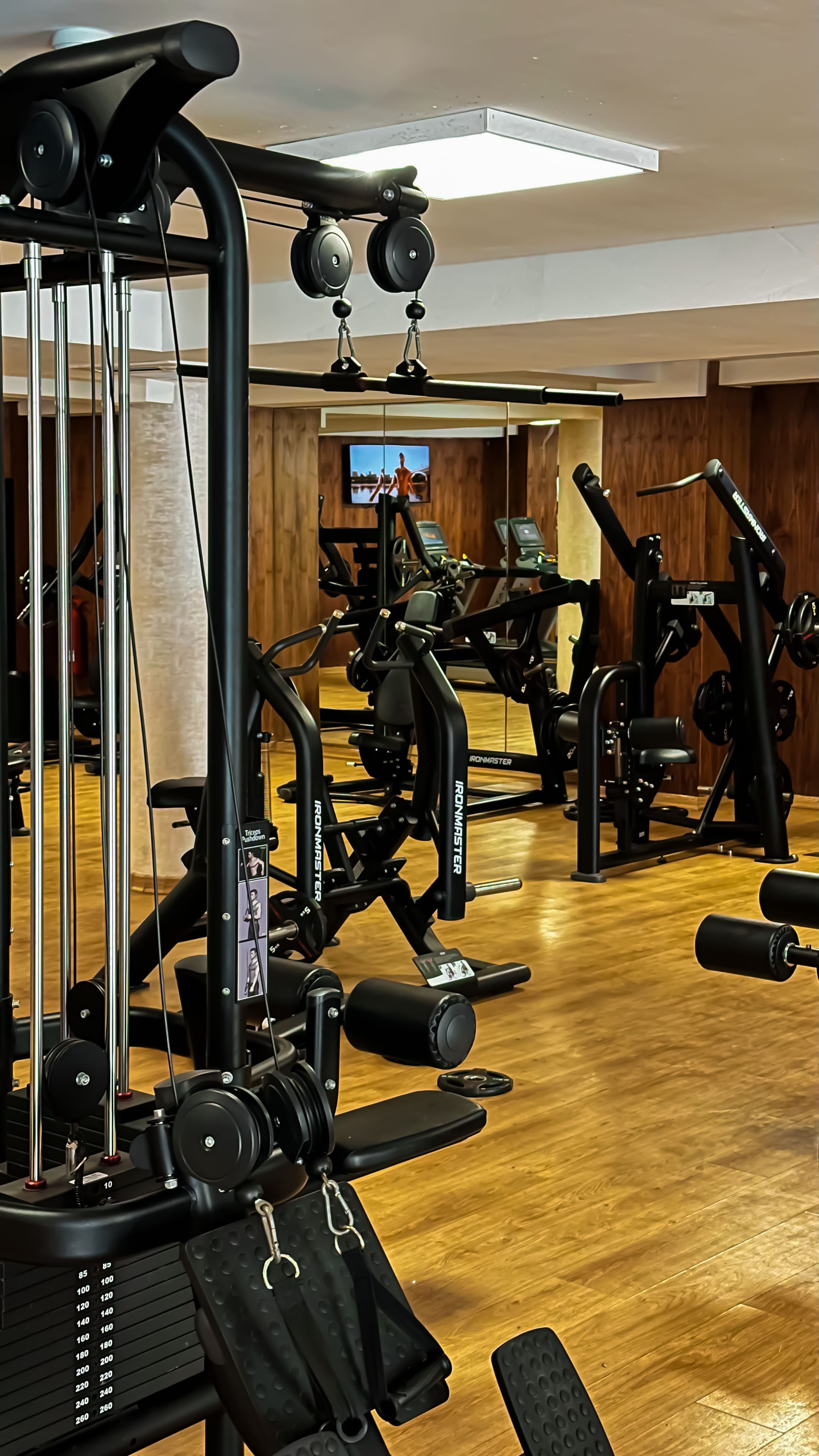 A gym with various exercise equipment, including weight machines and free weights.
