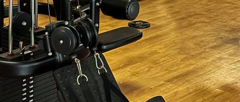 A gym with various exercise equipment, including weight machines and free weights.