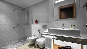 Un baño moderno con ducha, bidé, lavamanos y espejo.