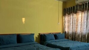A room with two beds, yellow walls, and a window with patterned curtains. - Naayina Vacation Villas #AS178
Your Home away from Home (Northern Region)
