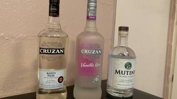 Three bottles of Cruzan rum on a table.