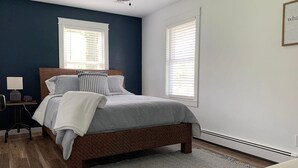 A bedroom with a bed, bedside tables, a desk, and a chair. - HOT TUB Beauitiful Backyard Oasis Newly Renovated (Middlebury)