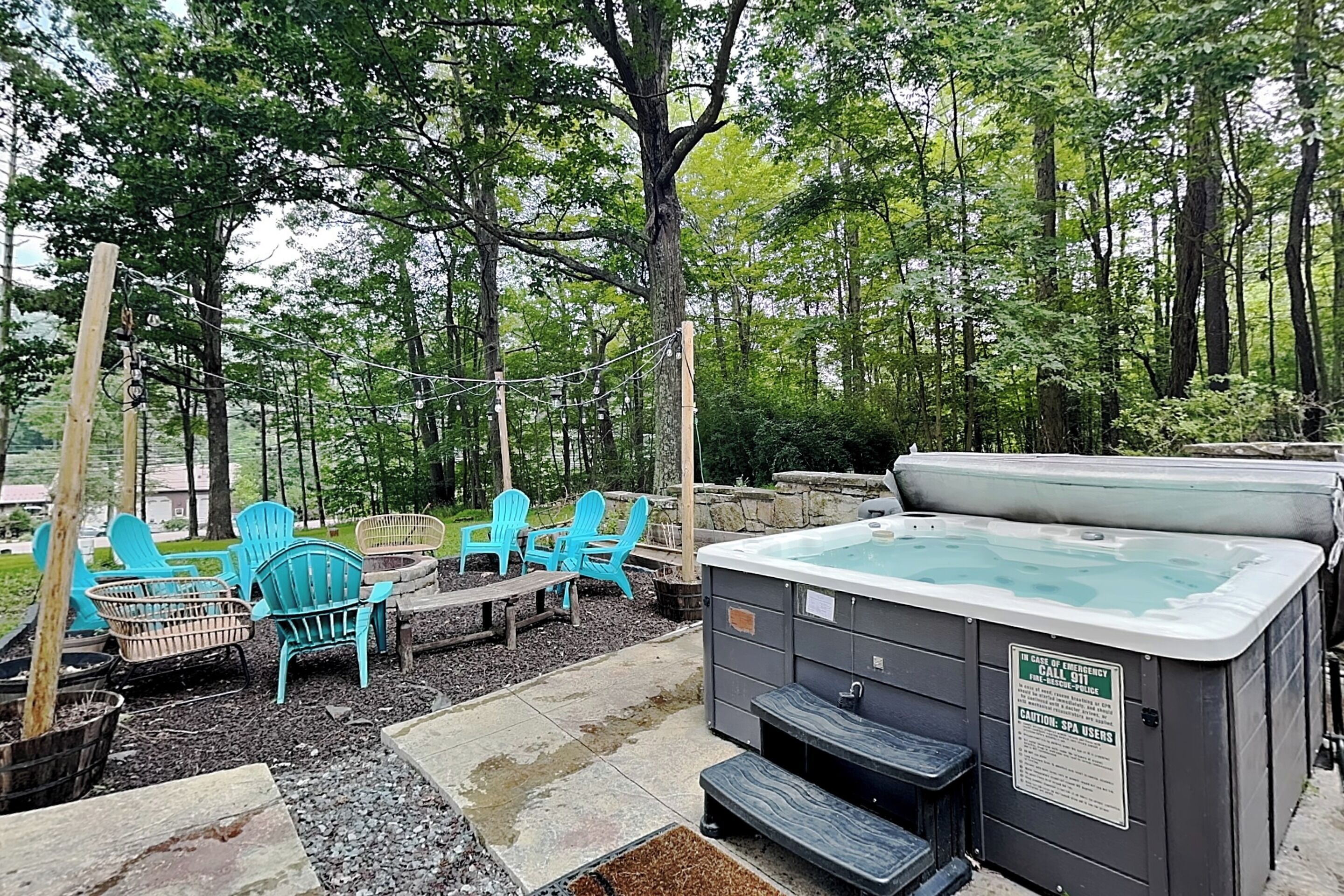 An outdoor hot tub area with seating and a wooden deck.