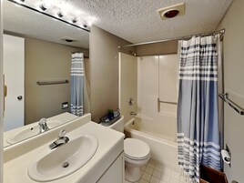 A bathroom with a sink, toilet, and bathtub.