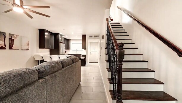 A modern interior with a staircase, a sofa, and a kitchen area. - Luxury Old Town 2BR/2BA • AC • 2 Pools • Parking (Scottsdale)