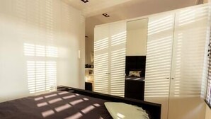 A bedroom with a bed, a wardrobe, and a mirror. - Spacious private apartment, 90m2, 25min from Amsterdam (Hilversum)