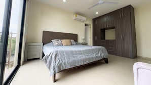 Un dormitorio con cama, armario, ventilador de techo y aire acondicionado.