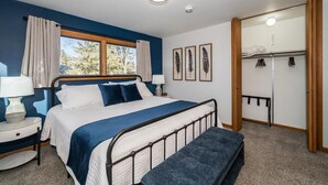 A bedroom with a bed, bedside tables, a bench, a wardrobe, and a window with curtains. - Family, Group Friendly, Large Yard, Only 6 Miles To Duluth, MN!  EV Charger (Superior)