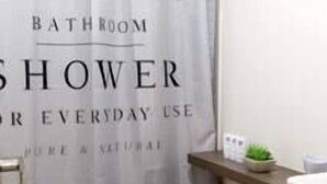 A bathroom with a shower curtain labeled "BATHROOM SHOWER FOR EVERYDAY USE" and a toilet with neatly rolled towels. - New and excellent conditions (Benito Juárez)