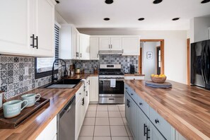 Fridge, coffee/tea maker, high chair, cookware/dishes/utensils