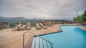 A pool area with lounge chairs and a view of mountains. - Pet-Friendly Cle Elum Condo - Hike, Ski & Relax! (Cle Elum)