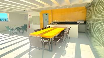 A modern kitchen with a yellow backsplash, a dining area with a long table and chairs, and a view of the outdoors through a window.