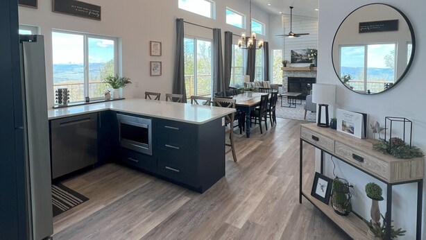 A spacious kitchen with a large island, modern pendant lights, and a dining area with a view. - Your Hideaway Surrounded by the Breathtaking Beauty of Utah's Natural Landscape (Fairview)