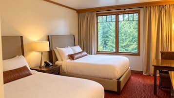 Cozy double-queen room with forest views and warm lodge-style comfort