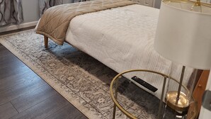 A bedroom with a bed, a ceiling fan, a lamp, and a window with curtains. - Red Mesa house  (Page)