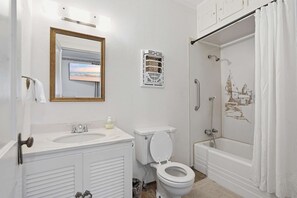 A bathroom with a sink, toilet, and shower.