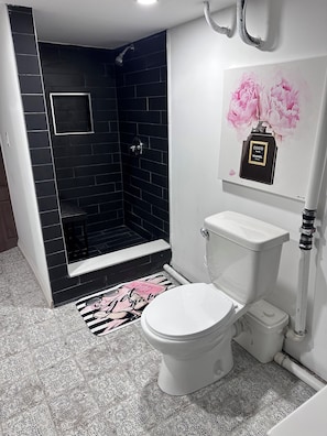 Een douche, handdoeken, zeep, toiletpapier