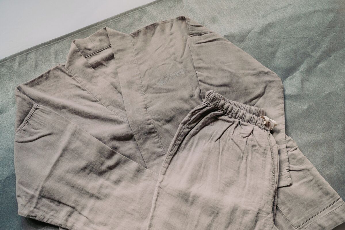 A folded piece of clothing on a textured surface.