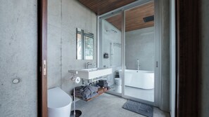 Separate tub and shower, bathrobes, slippers, electronic bidet