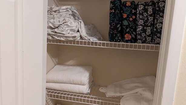 A closet with multiple shelves holding folded towels and patterned linens. - Gulf Coast Getaway Home-3 bed, 7m walk to bay beach and pier (Mary Esther)