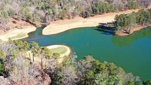 An aerial view of a golf course with two sand bunkers and a bridge. - Cozy condo in Big Canoe! - Misty Ridge (Jasper)