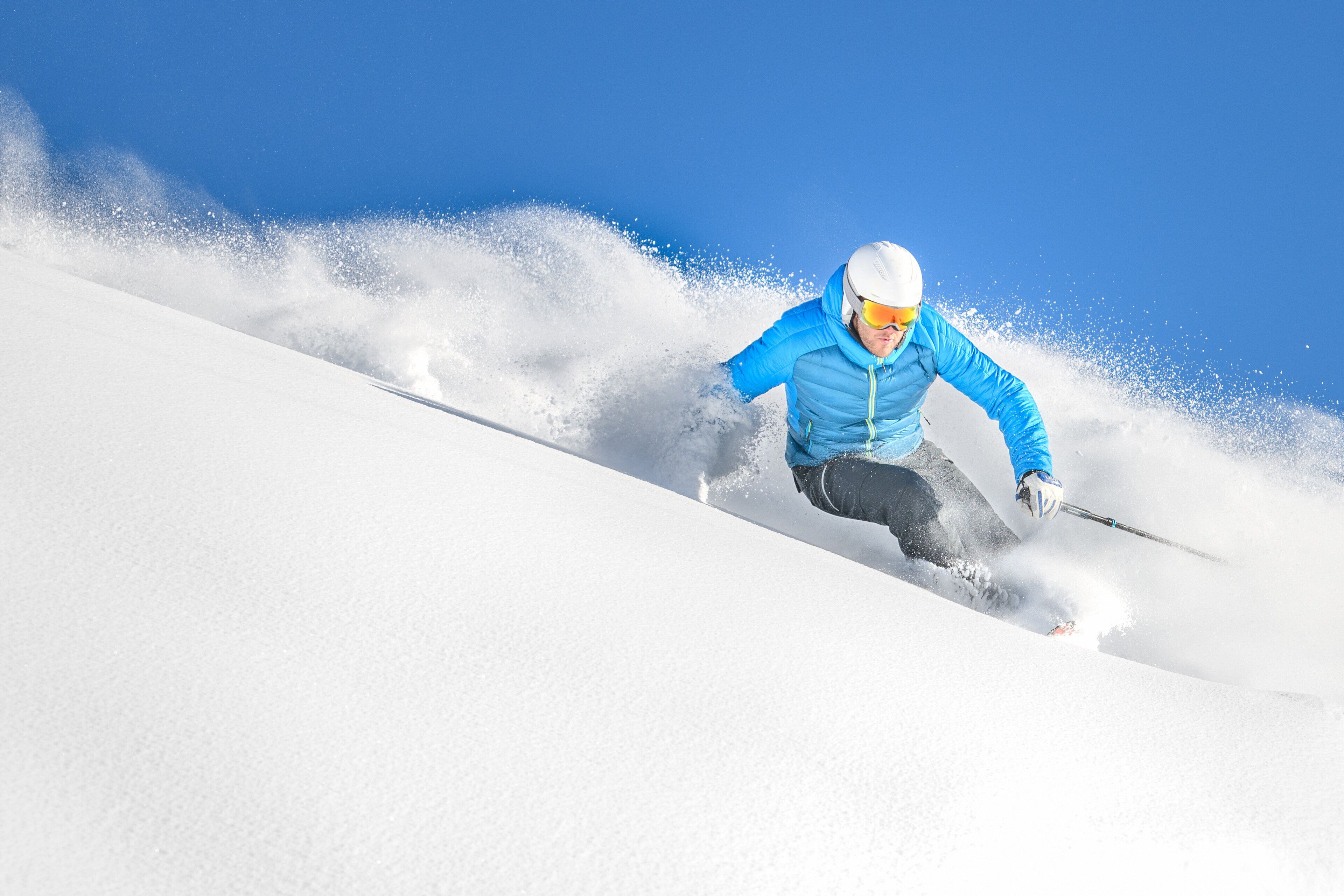 A person skiing down a snowy slope.