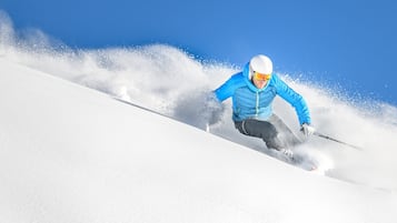 A person skiing down a snowy slope.