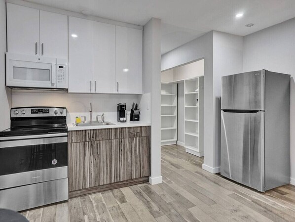 Fridge, microwave, stovetop, coffee/tea maker