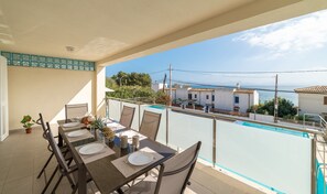 Enjoy a meal with a view of the sea from this balcony dining area.