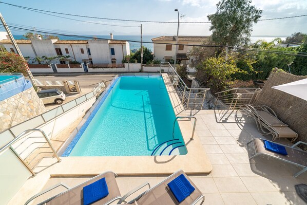 Relax by the pool surrounded by stunning views of the surrounding architecture and landscape.