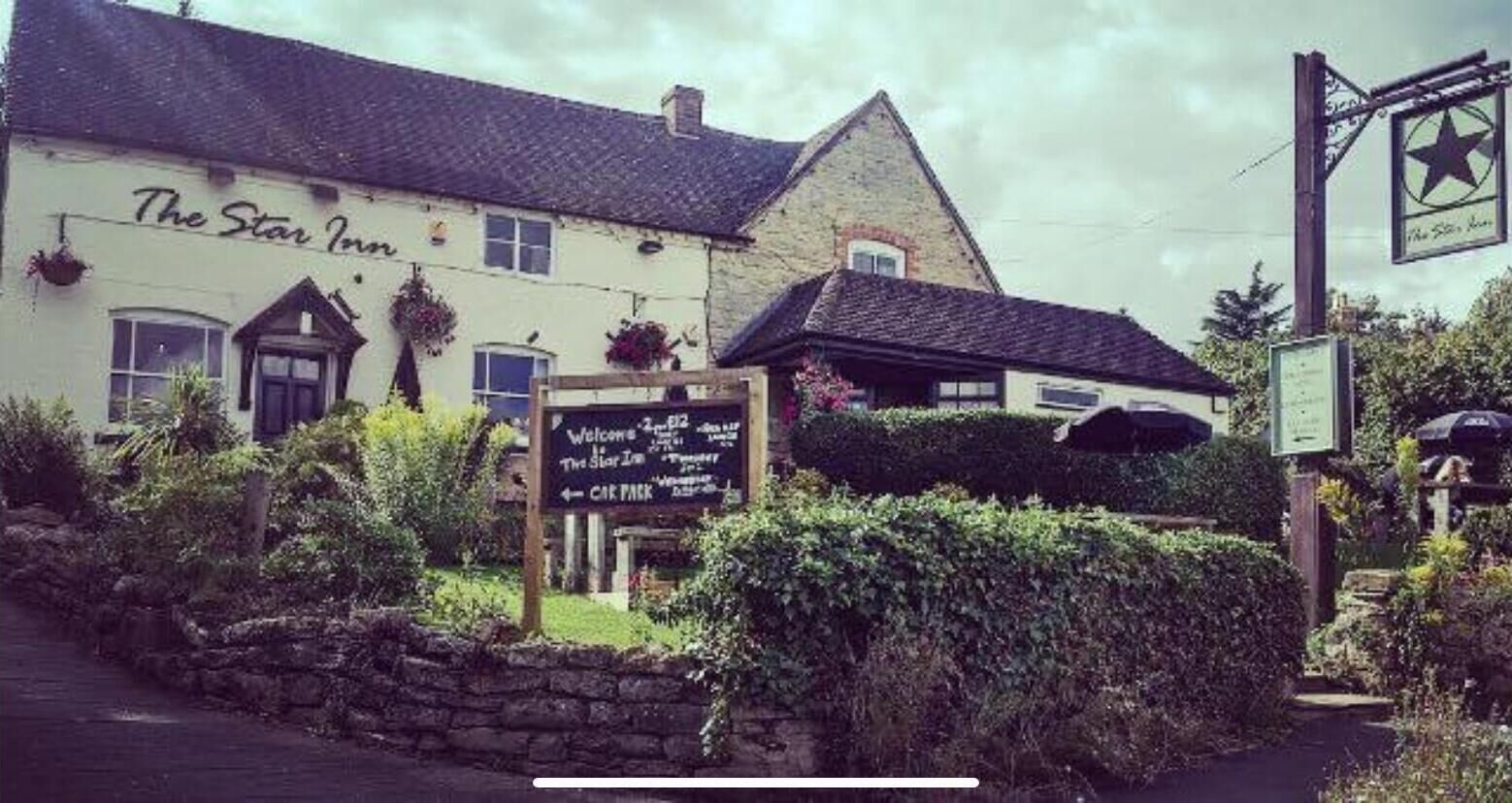 The Star Inn, a traditional building with a signboard indicating amenities and directions.