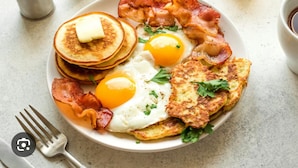 A breakfast plate with pancakes, eggs, bacon, and hash browns. - The Bella Vista – Traveler's Choice Awarded (New Delhi)
